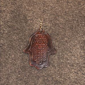Rust colored hamsa keychain with Hebrew writing